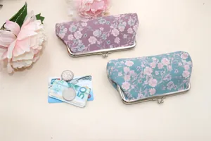Retro floral fabric kiss-lock wallets in purple and blue with metal clasp and coin pockets