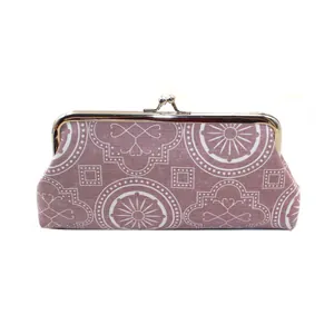 Detail of vintage purple geometric canvas pouch with a classic gold metal frame clasp