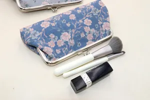 Vintage blue floral canvas makeup bag with silver metal frame closure and soft floral pattern