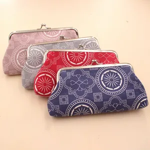 Detailed stack of geometric pattern fabric coin purses with vintage metal clasp closure