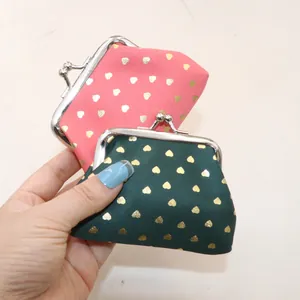 Pink and green fabric coin purses with gold heart patterns and metal kiss-lock closure