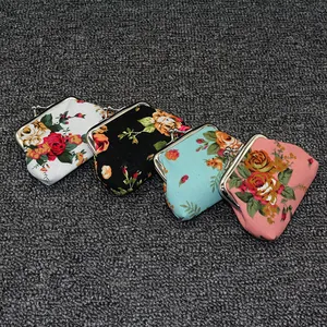 Close-up of four floral canvas coin purses with vintage metal clasps in various colors