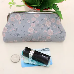 Detail of vintage floral fabric purse with metal clasp closure and interior storage space