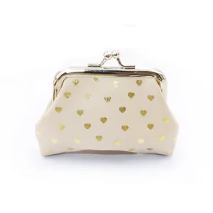 Close-up of cream fabric coin purse with gold heart pattern and silver kiss-lock clasp