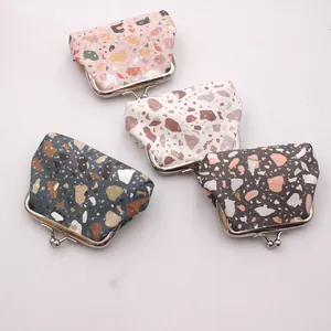 Detail view of four mini PU coin purses with terrazzo pattern and silver metal clasps