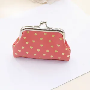 Detail of pink fabric mini coin purse with gold heart prints and silver kiss-lock closure
