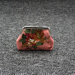 Close-up of pink floral canvas coin purse with vintage silver kiss-lock metal clasp