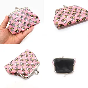 Detail view of pink PU coin purse with bee print and vintage metal kiss-lock closure