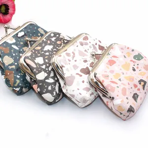Detailed view of four vintage terrazzo pattern coin purses with silver metal clasps