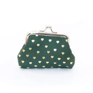 Detail of green fabric coin purse with gold heart pattern and metal clasp closure
