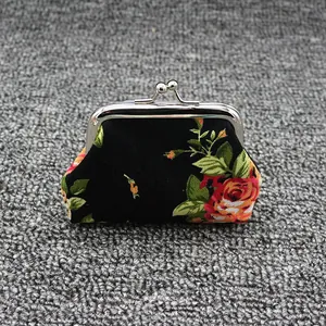 Detailed view of canvas coin purse with vintage floral print and silver metal clasp closure