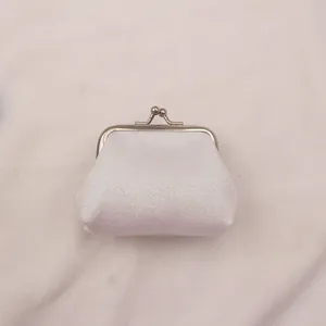 Détail d'un mini porte-monnaie pailleté de 3 pouces avec fermoir en métal et tissu argenté