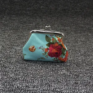 Detail of blue floral canvas coin purse with vintage red rose print and metal clasp