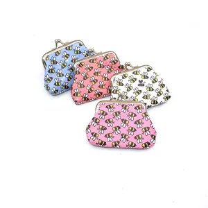 Close-up of four colorful mini kiss-lock coin purses with cute cartoon bee patterns