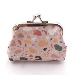 Close-up of a 3-inch mini coin purse with pink terrazzo pattern and silver kiss-lock