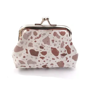 Detail of a vintage kiss-lock coin purse with stone pattern and glitter accents