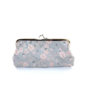 Vintage floral cloth clutch purse with pink flower patterns and metal kiss lock closure