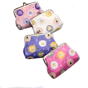 Detail of four colorful glitter coin purses with metal clasps and lion patterns