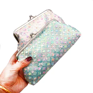 Detailopname van pailletten clutches met zilveren kiss-lock sluiting en parelmoerglans