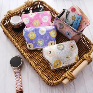 Detail of 4-inch glitter lion coin purses in a woven basket with metal clasps