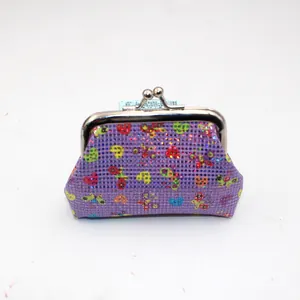 Detail of purple sequin coin purse with heart patterns and metal kiss-lock clasp