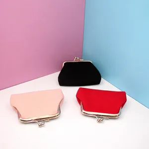 Three minimalist canvas coin purses with silver metal clasps in pink, black, and red colors