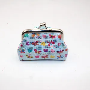 Detailed view of mini clasp coin purse featuring butterfly and heart laser patterns