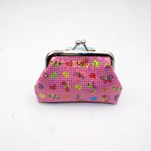 Detailed view of pink sequin coin purse with butterfly prints and metal clasp closure