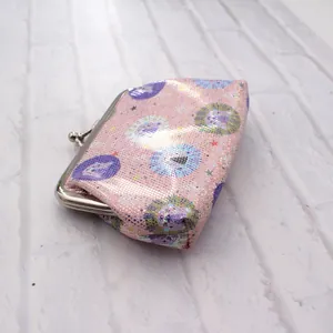Detail of pink laser PU mini coin purse with cartoon lion print and silver metal clasp