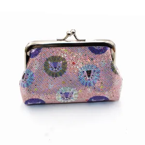 Close-up of pink sequin coin purse with cartoon lion print and silver metal clasp