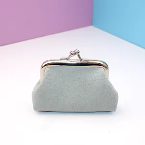 Macro view of a mini canvas coin purse with vintage kiss-lock metal clasp in grey
