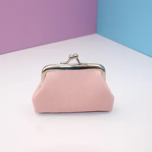 Close-up of pink canvas mini coin purse with silver metal frame clasp closure detail