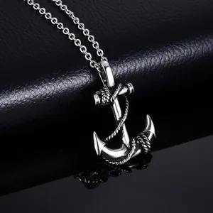 Vintage stainless steel anchor pendant necklace with rope details on a black leather background