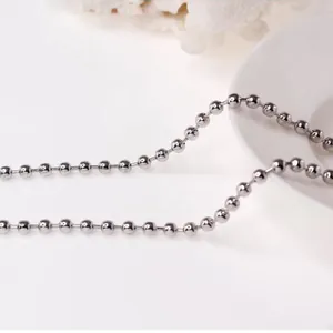 Macro shot of polished silver beaded chain links showing metallic texture and shine