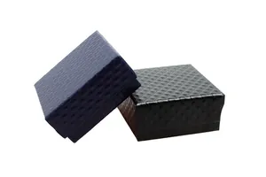 Close-up of quilted faux leather jewelry boxes in navy blue and black colors