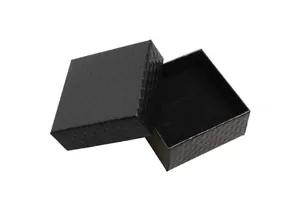 Detail of square black jewelry box with diamond texture and soft velvet interior lining