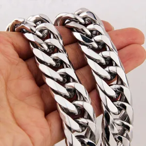 Macro shot of a heavy silver Cuban link chain necklace in polished stainless steel