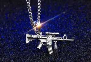 Detailed close-up of a silver stainless steel rifle pendant necklace on a bead chain