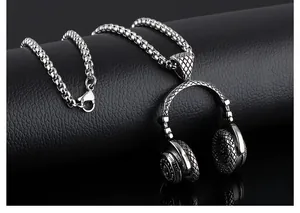 Macro shot of silver-tone headphone pendant with industrial textured details and chain