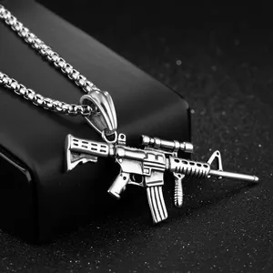 Detailed close-up of a stainless steel rifle pendant on a square box chain with metallic finish