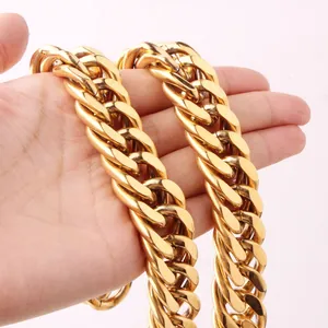 Close-up of thick gold Cuban link chain held in hand showing texture and size