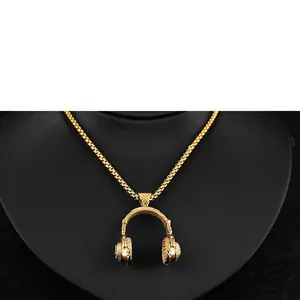Detailed close-up of a gold headphone pendant necklace with quilted texture on black bust