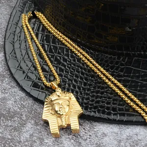 Detailed macro view of golden Egyptian Pharaoh pendant with intricate 3D embossed texture
