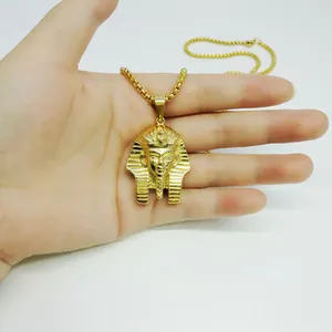 Close-up of golden Egyptian pharaoh Tutankhamun pendant with square box chain jewelry