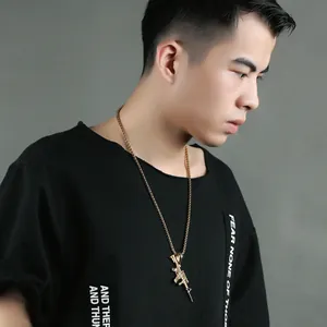 Men's hip hop gold stainless steel rifle pendant necklace with thin chain on male model