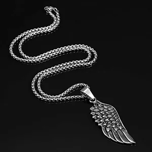 Detailed view of silver wing pendant with intricate metal texture on wheat chain