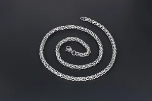 Detailed macro view of silver stainless steel spiga chain with secure lobster clasp