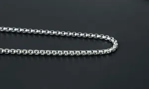 Macro shot of polished silver stainless steel box chain link necklace for men