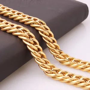 Detail of a thick golden Franco chain with tightly woven V-shaped links and metal luster
