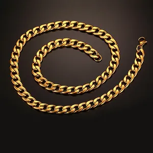 Macro shot of heavy golden cuban link chain with lobster clasp on reflective black base